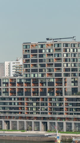 Panoramic aerial timelapse of Katendrecht peninsula and Maashaven harbour in Rotterdam, The Netherlands. City skyline at morning, modern skyscrapers and Euromast, waterfront with ships