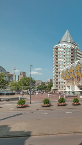 Hyperlapse of Cube House (Kubuswoningen) in Rotterdam. Unique yellow cube-shaped houses showcasing innovative architecture amid cityscape aerial timelapse. Cloudy sky and urban vibrancy. Netherlands
