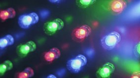 Close-up panning shot moves over flashing RGB LED lights on an electronic panel showing soft-focus red green and blue diodes pulsing with vibrant energy creating a dynamic colorful light show. - Powered by Shutterstock - Get 15% off with code: PIKWIZARD15