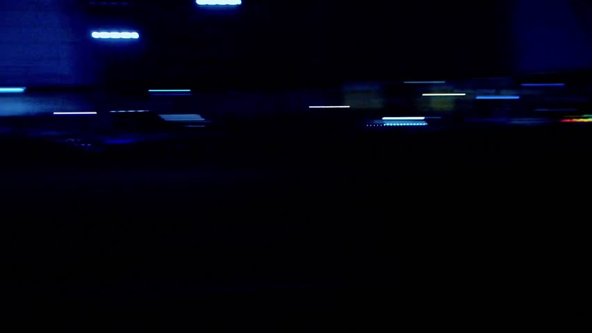 Cars of different classes pass in pairs in a drift on the drift track. Night lights of a big city. Russia. Moscow. 01.11.2025