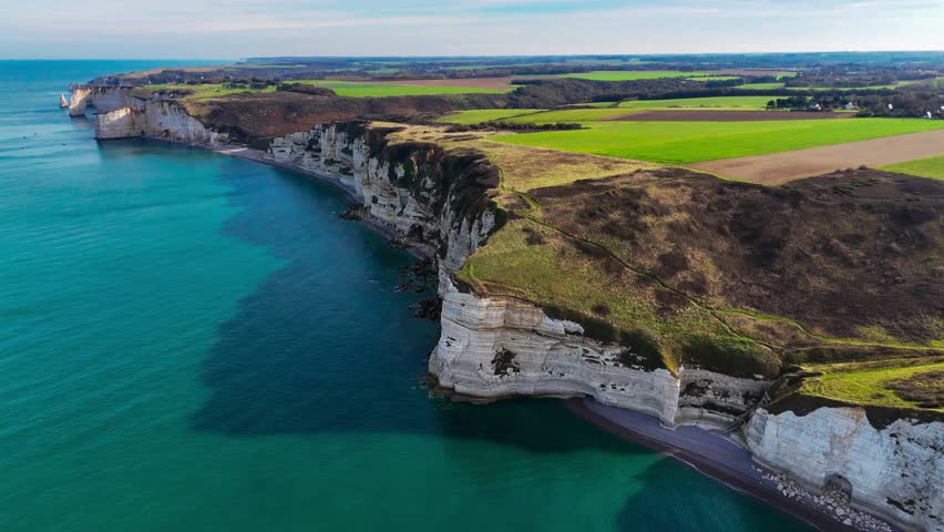 Aerial drone view of picturesque coastal limestone cliffs and the English Channel town of Etretat, France. High quality 4k footage