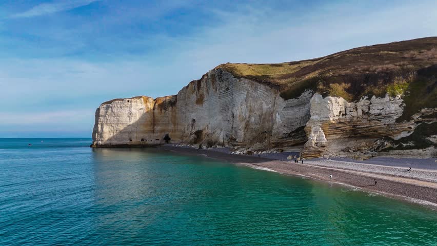 Aerial drone view of picturesque coastal limestone cliffs and the English Channel town of Etretat, France. High quality 4k footage