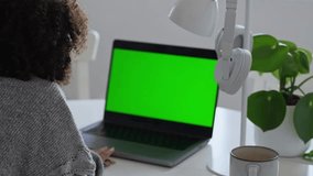 Primary school Student African American child with headphones using laptop green screen chroma key. Distance learning online education. Schoolboy girl studying at home with digital tablet computer and - Powered by Shutterstock - Get 15% off with code: PIKWIZARD15