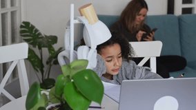 Primary school Student African American child with headphones using laptop green screen chroma key. Distance learning online education. Schoolboy girl studying at home with digital tablet computer and - Powered by Shutterstock - Get 15% off with code: PIKWIZARD15
