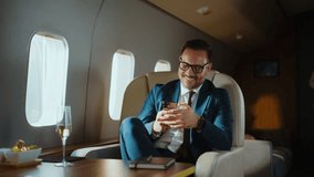 Two successful colleagues enjoying a comfortable flight in a private jet, laughing and interacting while looking at a smartphone, representing a luxurious business travel lifestyle - Powered by Shutterstock - Get 15% off with code: PIKWIZARD15