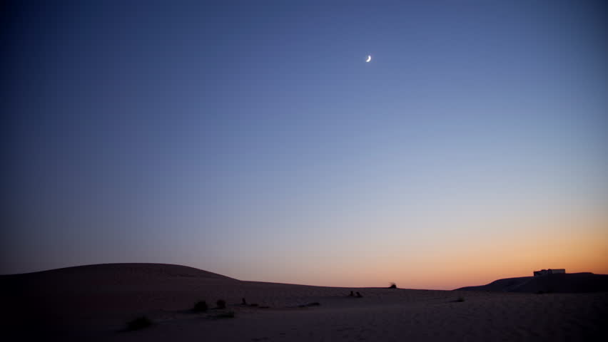 Stunning 4k timelapse of the night sky transition of moonset and Milky Way galaxy motion in the desert sand dune.  stars scape in a remote wilderness location.