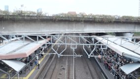Pulled over at the descended pole barrier at the railroad intersection looking at the railway tracks and a loaded freight train passing by shipping bulk, oil in tanks and heavy cargo and passenger - Powered by Shutterstock - Get 15% off with code: PIKWIZARD15