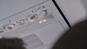 Fasten seatbelt sign is turned on during airplane flight to warn passengers. Overhead alert or caution sign or signal to put on seatbelts on plane is lit while onboard. Turbulence or landing procedure - Powered by Shutterstock - Get 15% off with code: PIKWIZARD15