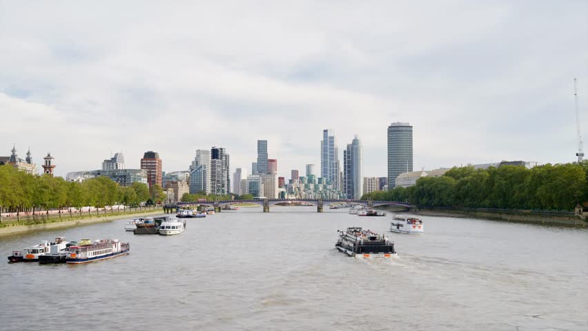 Scenic view of the Canary Wharf financial district in London, United Kingdom, seen from Westminster Bridge, showcasing modern skyline and River Thames.
