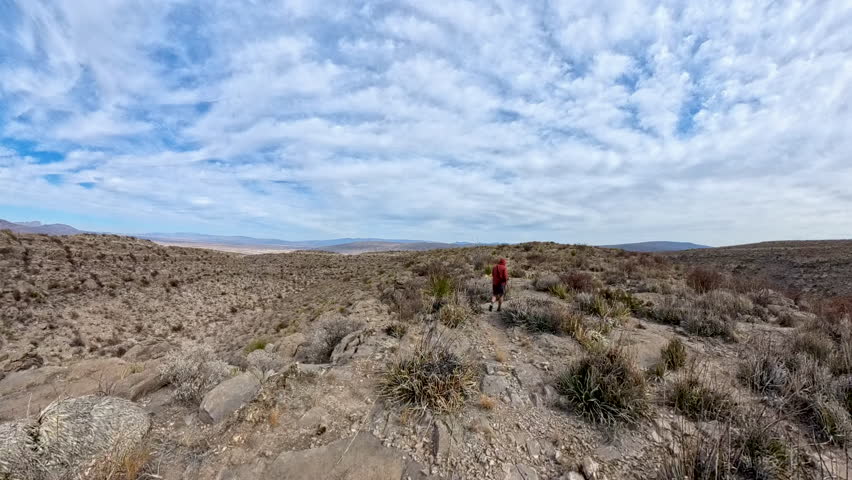 Man Hikes On Trail Over Desert Rock in Big Bend National Park
