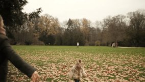 Clear moment in autumn park mother lifts child high, sharing joy and bonding. Autumn colors, autumn chill, warm clothes, playful mood, gentle wind, cozy family time, happy outdoor routine - Powered by Shutterstock - Get 15% off with code: PIKWIZARD15