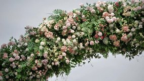 Lush floral arrangement forming an arch against a simple backdrop - Powered by Shutterstock - Get 15% off with code: PIKWIZARD15