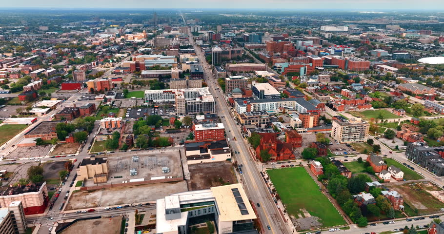 Footage over the neighborhoods of modern Detroit, Michigan, USA. Flying over the long straight highway crossing the city scenery.