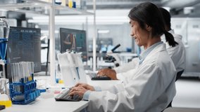 Assay development specialist uses pipette to transfer liquid into test tube containing blue solution at laboratory bench. Asian lab engineer does pipetting procedure with chemical reagent, camera B - Powered by Shutterstock - Get 15% off with code: PIKWIZARD15