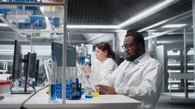 Portrait of smiling laboratory scientist using computer monitor, processing DNA patient data for clinical research. Cheerful african american lab worker looking at analysis diagnostics on PC, camera A - Powered by Shutterstock - Get 15% off with code: PIKWIZARD15