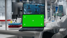 Cytotechnologist works on green screen laptop in lab, studying genomics information. African american man studies DNA strand mapping on mockup notebook, contributing to scientific innovation, camera B - Powered by Shutterstock - Get 15% off with code: PIKWIZARD15