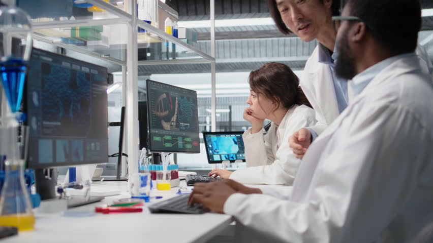 Diagnostic laboratory manager overseeing scientists looking at molecular models on PC. Team leader supervising researchers using bioengineering program on computer in medical lab, camera A - Powered by Shutterstock - Get 15% off with code: PIKWIZARD15