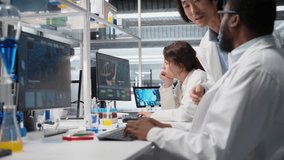 Diagnostic laboratory manager overseeing scientists looking at molecular models on PC. Team leader supervising researchers using bioengineering program on computer in medical lab, camera A - Powered by Shutterstock - Get 15% off with code: PIKWIZARD15