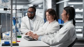 Diverse team of research facility professional using PC software to evaluate genetic marker associated with disease risk. Multiracial coworkers study DNA strand mapping, camera B - Powered by Shutterstock - Get 15% off with code: PIKWIZARD15