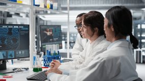 Multiracial lab technicians at PC desk looking at 3D molecular model. Diverse nanotechnology researchers using bioengineering program on PC in medical lab displaying DNA data, camera B - Powered by Shutterstock - Get 15% off with code: PIKWIZARD15