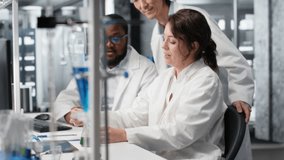 Multiracial researchers in lab inspecting liquids in test tube, looking for breakthroughs during clinical trials. Multiethnic employees comparing chemicals vials, testing right formula, camera B - Powered by Shutterstock - Get 15% off with code: PIKWIZARD15