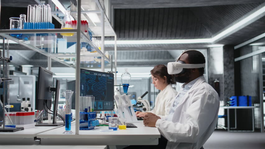 Scientist using computer and VR headset equipment for DNA data analysis in laboratory. African american man using bioinformatics genomics software and virtual reality tech in modern lab, camera A - Powered by Shutterstock - Get 15% off with code: PIKWIZARD15
