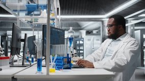 Chemical engineer in lab inspecting chemical compounds in vials for purity verification using PC software. Man in laboratory preparing reagent test tubes for assay procedures on computer, camera A - Powered by Shutterstock - Get 15% off with code: PIKWIZARD15