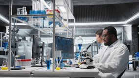 Laboratory scientist using computer to process DNA patient data, communicating results to coworkers. Lab expert uses PC to do lab genetic analysis diagnostics, sharing data with colleagues, camera A - Powered by Shutterstock - Get 15% off with code: PIKWIZARD15