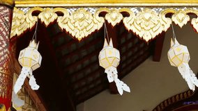 Traditional thai lanterns hanging under ornate golden eaves in a temple setting - Powered by Shutterstock - Get 15% off with code: PIKWIZARD15