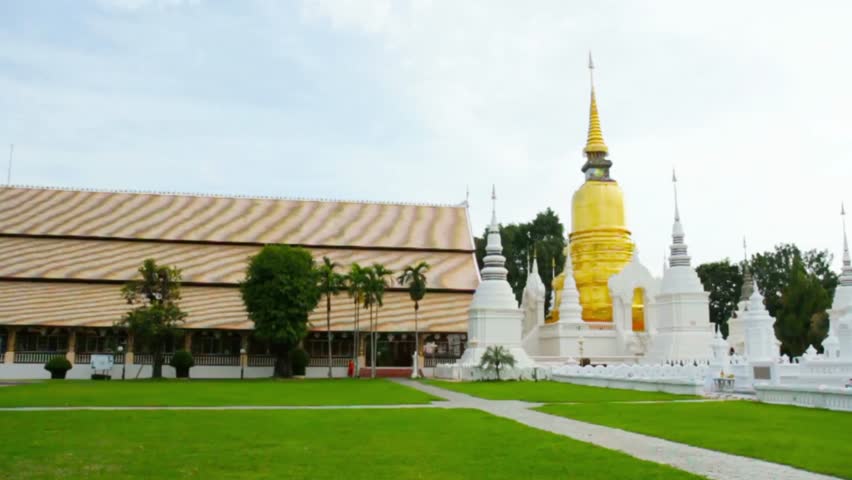 Golden pagoda and white monuments at Wat Suan Dok temple in Chiang Mai Thailand