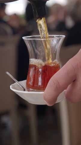 Serving turkish tea at a bustling cafe in the afternoon