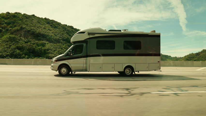 Camper van traveling on the highway, slow motion 4k, Los angles, California, United States - March 26 2023 - Powered by Shutterstock - Get 15% off with code: PIKWIZARD15