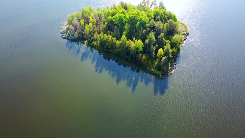 Russia, Lake Ladoga, Koyonsaari. View of the coast of the island in a cold lake. Beautiful nature of the Republic of Karelia. Panoramic view from the height of the Ladoga skerry islands. 4K