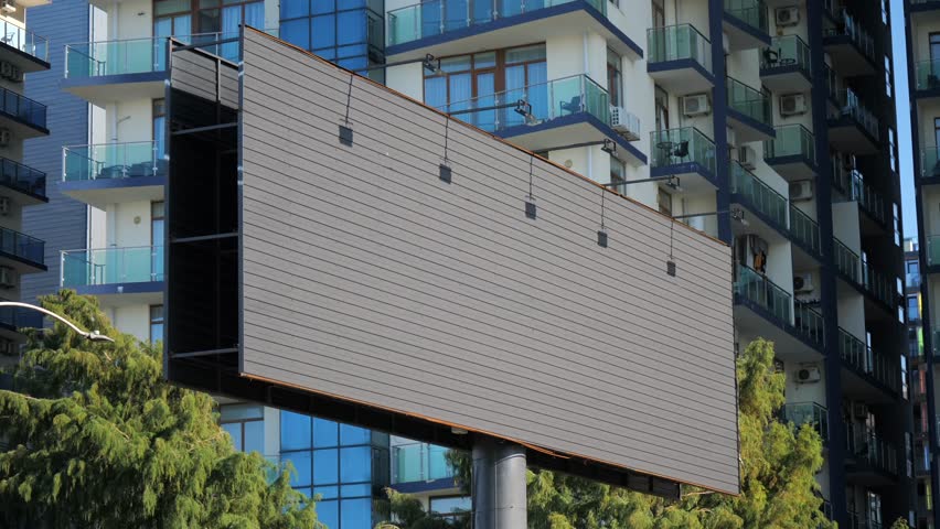 Empty billboard in urban city with modern apartment building background. Outdoor advertising mockup, marketing, promotion