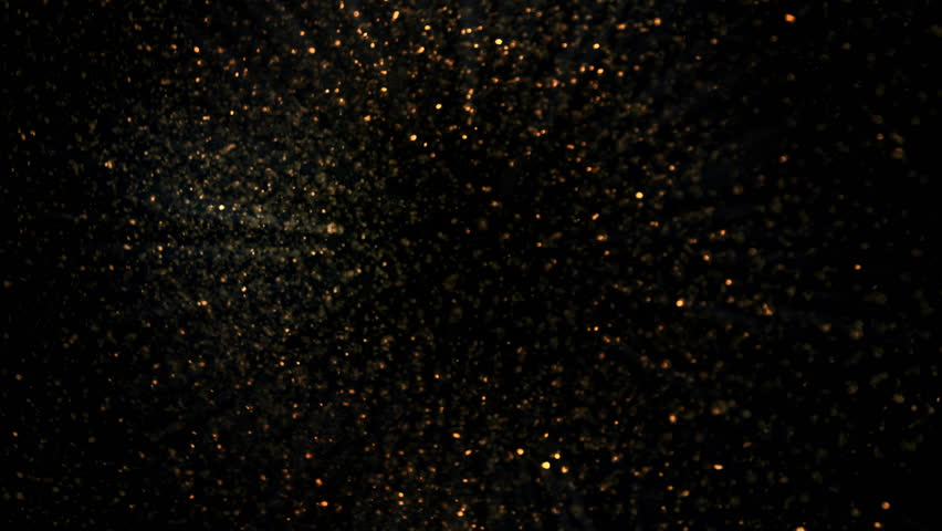 Super Slow Motion Shot of Rotating Golden Glitters Towards Camera Isolated on Black 1000fps.