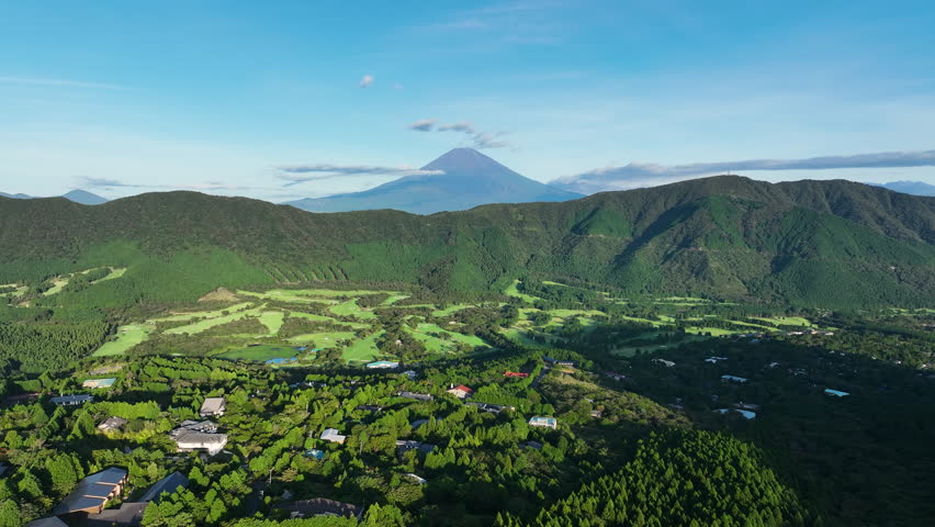 Lush Green Golf Course In Hakone, Japan, With Majestic Mount Fuji In Background. wide aerial shot