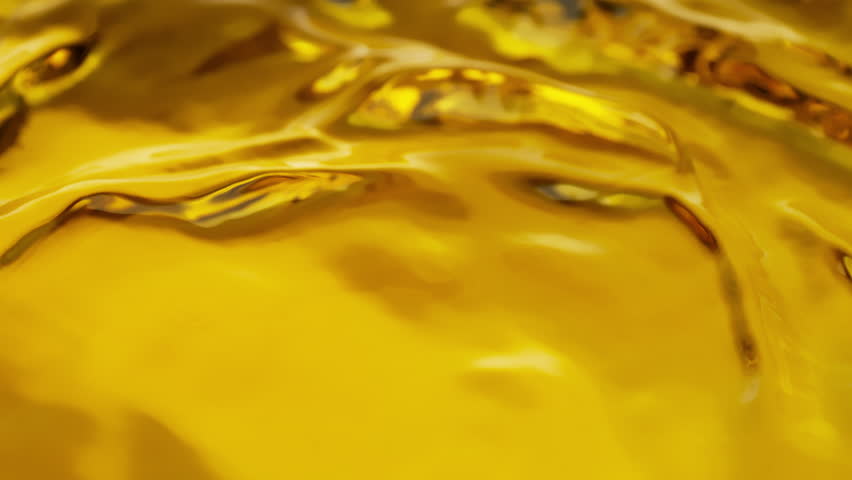 Super Slow Motion Shot of Pouring and Splashing Golden Oil Liquid at 1000fps.