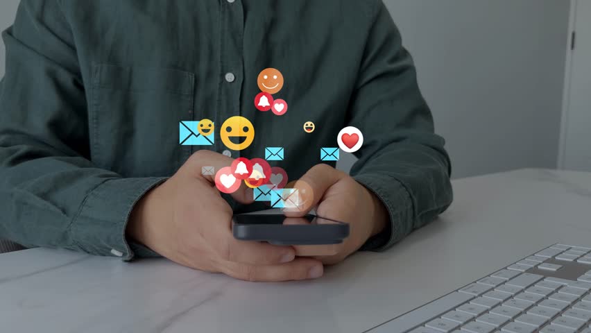 Interactive with friends on chat with emoticon feedback.Social media,marketing, like,social network,blog,live,chat reaction and livestream.Person using smart phone with emoticon icons of Social Media.