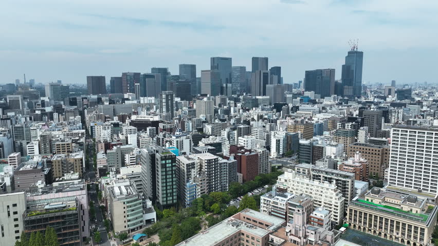 Daytime Aerial View Of Dense Urban Skyline Of Tokyo In Japan. wide shot