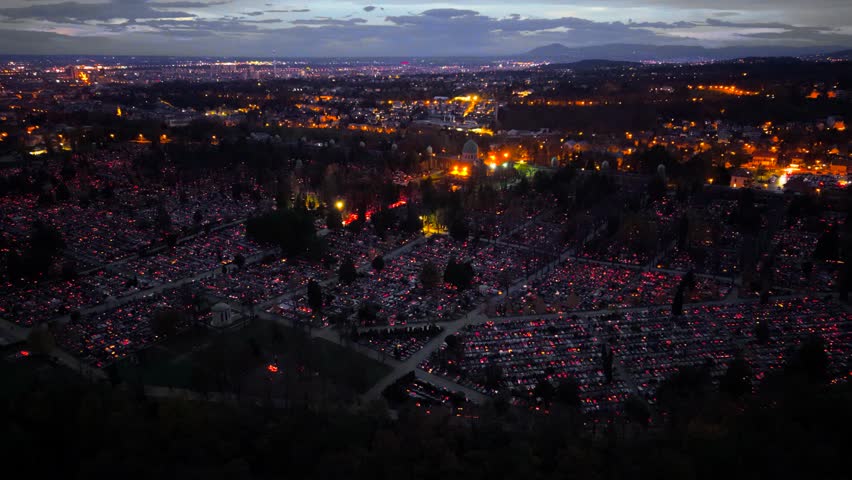 Aerial view of the illuminated Mirogoj Cemetery at dusk, a sea of lights contrasting against the dark landscape, Mirogoj Cemetery, Grad Zagreb, Croatia.