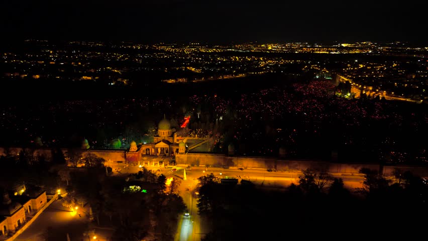 Aerial view of the illuminated Mirogoj Cemetery, its stately architecture glowing warmly against the dark expanse of the night, Grad Zagreb, Croatia.