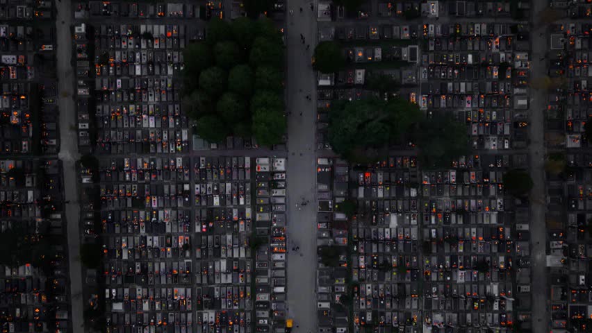 Aerial view of the Mirogoj Cemetery illuminated with vibrant orange candles creating a striking contrast against the dark tombstones, Mirogoj, Grad Zagreb, Croatia.