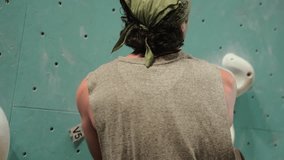 Man Climbing Up Artificial Wall In Gym - Tracking Shot - Powered by Shutterstock - Get 15% off with code: PIKWIZARD15