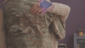 A child hugs a soldier holding an American flag. Emotional reunion after military duty, love and sacrifice.
 - Powered by Shutterstock - Get 15% off with code: PIKWIZARD15