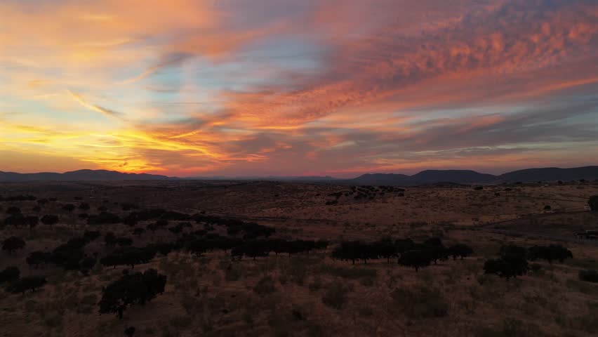 Drone footage of a colorful sunset over dry hills and countryside near Cote, Andalusia, southern Spain.