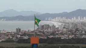 Brazilian flag waving with panoramic skyline of Balneario Camboriu in Santa Catarina Brazil, national pride and tourism development - Powered by Shutterstock - Get 15% off with code: PIKWIZARD15