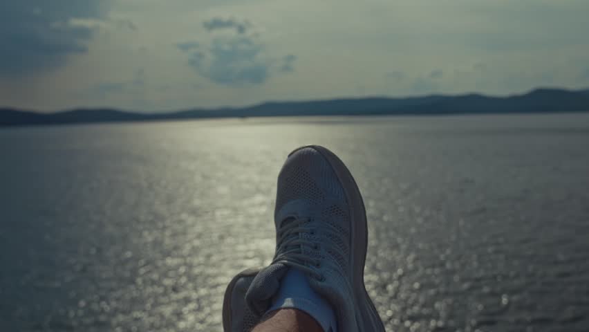 Sneakers POV shot overlooking a scenic vacation bay