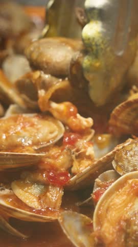 Hot chili butter clams served with soft mantao buns, combining spicy, savory, and buttery flavors. A mouthwatering seafood dish perfect for adventurous food lovers and vibrant dining experiences