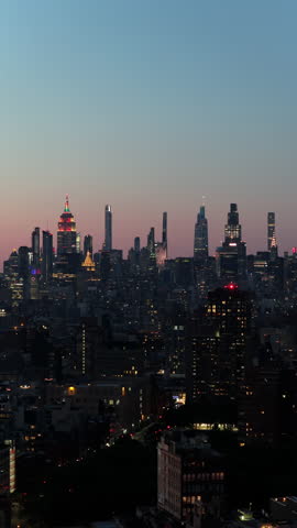 silky gradient sunset over peaceful urban skyline dotted with radiant skyscrapers and scattered