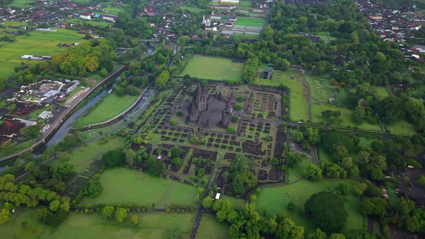 Aerial view of Prambanan Temple surrounded by lush greenery, showcasing the architectural marvel against the backdrop of the landscape, Yogyakarta, Jawa Tengah, Indonesia.